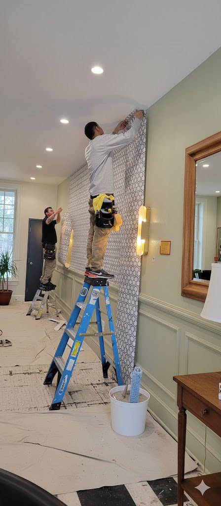Professional wallpaper installation team at work